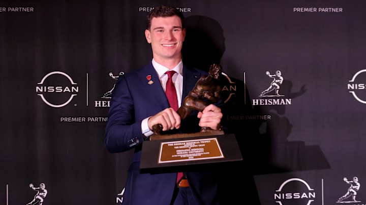 Dec 13, 2025; New York, NY, USA; Indiana Hoosiers quarterback Fernando Mendoza poses for photos with the Heisman trophy during a press conference at the New York Marriott Marquis after winning the award. Mandatory Credit: Brad Penner-Imagn Images