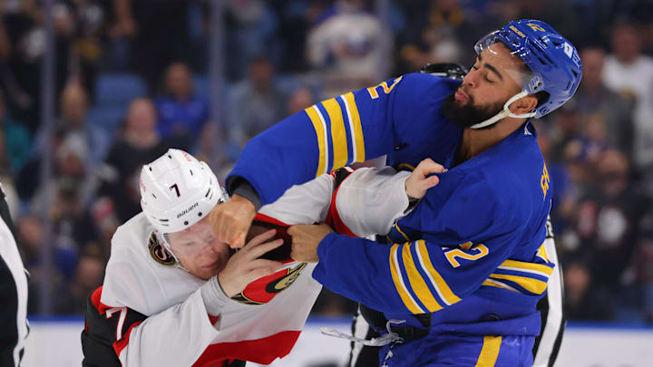 Nov 5, 2024; Buffalo, New York, USA;  Ottawa Senators left wing Brady Tkachuk (7) and Buffalo Sabres left wing Jordan Greenway (12) fight during the first period at KeyBank Center. Mandatory Credit: Timothy T. Ludwig-Imagn Images