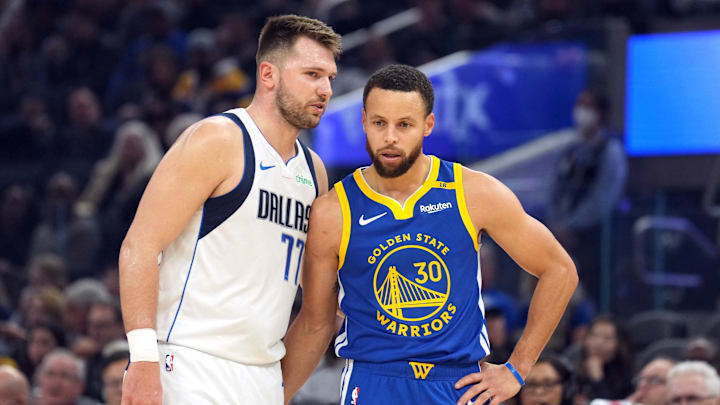 Dec 15, 2024; San Francisco, California, USA; Dallas Mavericks guard Luka Doncic (77) talks to Golden State Warriors guard Stephen Curry (30) during the first quarter at Chase Center. Mandatory Credit: Darren Yamashita-Imagn Images