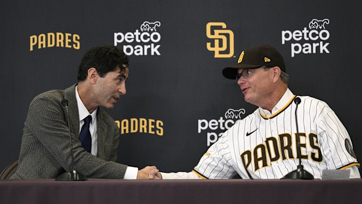 Nov 21, 2023; San Diego, CA, USA; San Diego Padres manager Mike Shildt (right) shakes hands with president of baseball operations and general manager A.J. Preller during a press conference announcing the hiring of Shildt at Petco Park. Mandatory Credit: Orlando Ramirez-Imagn Images