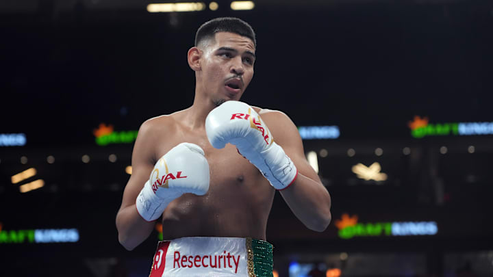 Diego Pacheco (white trunks) and Enrique Collazo (green trunks) box during their boxing bout at T-Mobile Arena. 