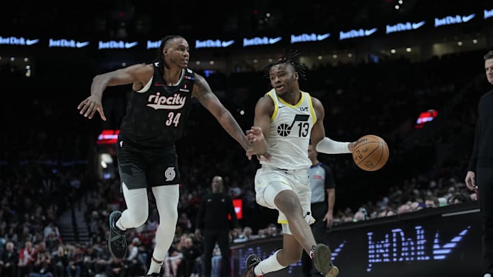 Dec 6, 2024; Portland, Oregon, USA; Utah Jazz guard Isaiah Collier (13) dribbles the ball against Portland Trail Blazers forward Jabari Walker (34)  during the second half at Moda Center. Mandatory Credit: Soobum Im-Imagn Images