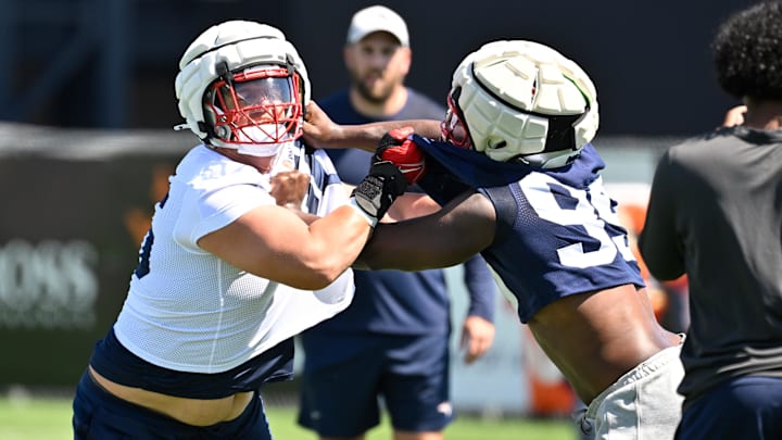 Jul 23, 2025; Foxborough, MA, USA; New England Patriots offensive tackle Will Campbell (66) and defensive end Keion White (99) work on a drill during training camp at Gillette Stadium. Mandatory Credit: Eric Canha-Imagn Images
