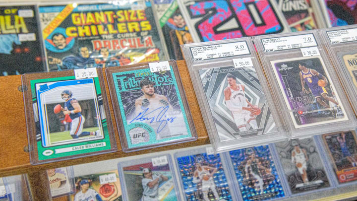 Rare sports cards, some graded for quality, sit in a display shelf at the new shop Stooges Comics & Collectibles in the Oak Cliff Park shopping center in Peoria.