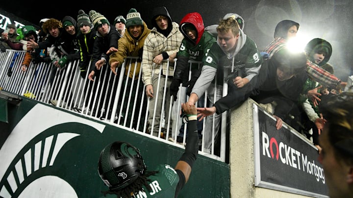 Nov 22, 2024; East Lansing, Michigan, USA;  fans scramble for souvenirs after the Michigan State Spartans beat the Purdue Boilermakers at Spartan Stadium. Mandatory Credit: Dale Young-Imagn Images