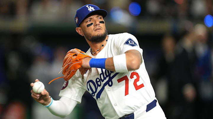 Mar 19, 2025; Bunkyo, Tokyo, JPN; Los Angeles Dodgers shortstop Miguel Rojas (72) throws a ball into the stands before the game against the Chicago Cubs during the Tokyo Series at Tokyo Dome. Mandatory Credit: Darren Yamashita-Imagn Images