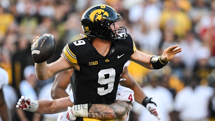 Sep 27, 2025; Iowa City, Iowa, USA; Indiana Hoosiers linebacker Aiden Fisher (4) hits Iowa Hawkeyes quarterback Hank Brown (9) during the fourth quarter at Kinnick Stadium. Mandatory Credit: Jeffrey Becker-Imagn Images
