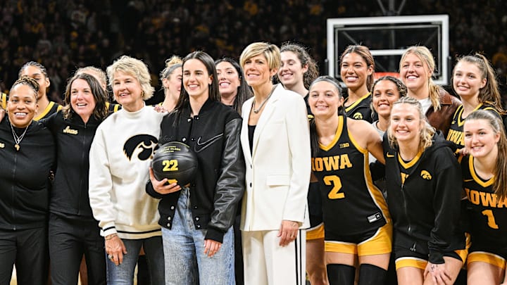 Former Iowa Hawkeyes player Clark reacts with former coaches and current Hawkeye players after the game at Carver-Hawkeye Arena against the USC Trojans. The Hawkeyes retired the jersey of Clark after the game. 
