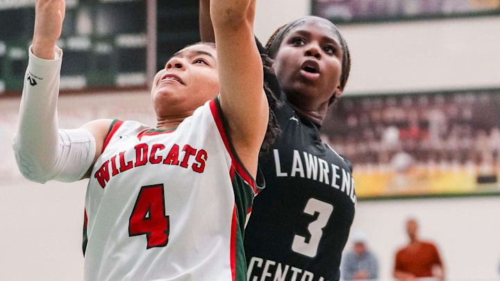 Lawrence Central Bears Lola Lampley (3) attempts to block Lawrence North Wildcats guard Kya Hurt (4) on Thursday, Jan. 16, 2025, during a high school girls basketball game between the Lawrence North Wildcats and the Lawrence Central Bears at Lawrence North High School in Indianapolis. The Bears defeated the Wildcats, 68-44.