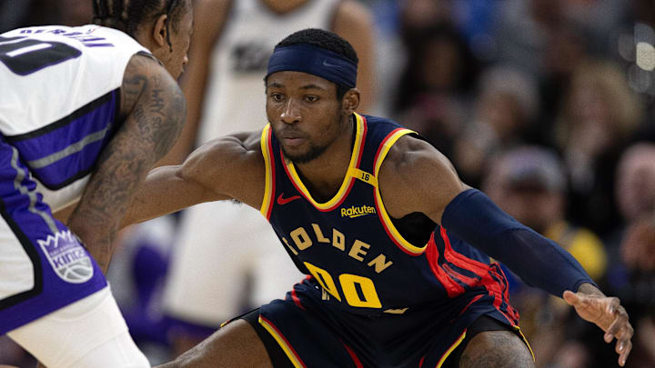 Mar 13, 2025; San Francisco, California, USA; Golden State Warriors forward Jonathan Kuminga (00) guards Sacramento Kings guard DeMar DeRozan (10) during the third quarter at Chase Center. Mandatory Credit: D. Ross Cameron-Imagn Images