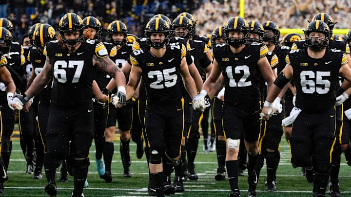 The Iowa Hawkeyes swarm to the Floyd of Rosedale Trophy after defeating the Minnesota Golden Gophers Oct. 25, 2025 at Kinnick Stadium in Iowa City, Iowa. The Iowa Hawkeyes swarm to the Floyd of Rosedale Trophy after defeating the Minnesota Golden Gophers Oct. 25, 2025 at Kinnick Stadium in Iowa City, Iowa.