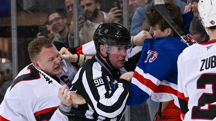 Jan 21, 2025; New York, New York, USA;  linesman Dan Kelly (98) gets in between New York Rangers center Matt Rempe (73) and Ottawa Senators left wing Brady Tkachuk (7) during the third period at Madison Square Garden. Mandatory Credit: Dennis Schneidler-Imagn Images