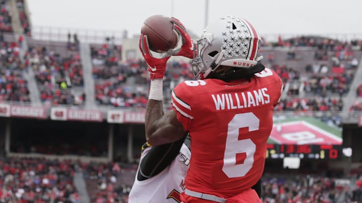 Ohio State Buckeyes wide receiver Jameson Williams (6) reels in a pass while defended by Maryland Terrapins defensive back Lavonte Gater (37) during the first half of Saturday's NCAA football game at Ohio Stadium in Columbus on November 9, 2019.