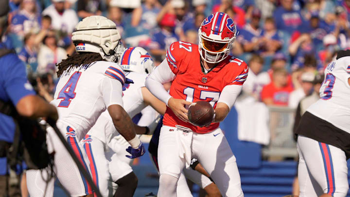 Buffalo Bills quarterback Josh Allen hands the ball off to running back James Cook during the Return of the Blue & Red practice at Highmark Stadium in Orchard Park on Aug.1, 2025.
