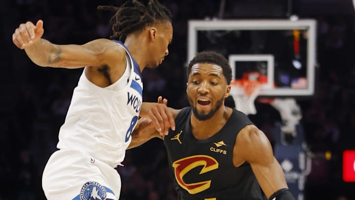 Jan 8, 2026; Minneapolis, Minnesota, USA; Cleveland Cavaliers guard Donovan Mitchell (45) works around Minnesota Timberwolves guard Bones Hyland (8) in the second quarter at Target Center. Mandatory Credit: Bruce Kluckhohn-Imagn Images