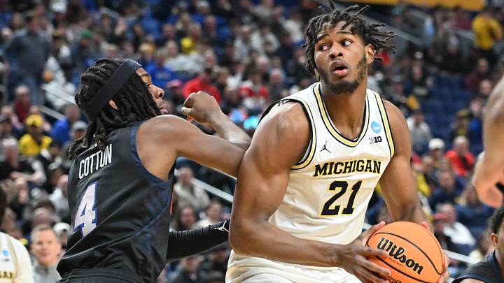Mar 19, 2026; Buffalo, NY, USA; Michigan Wolverines forward Morez Johnson Jr. (21) looks to shoot the ball against Howard Bison guard Alex Cotton (4) during the second half of a first round game of the men's 2026 NCAA Tournament at Keybank Center. Mandatory Credit: Mark Konezny-Imagn Images Mar 19, 2026; Buffalo, NY, USA; Michigan Wolverines forward Morez Johnson Jr. (21) looks to shoot the ball against Howard Bison guard Alex Cotton (4) during the second half of a first round game of the men's 2026 NCAA Tournament at Keybank Center. Mandatory Credit: Mark Konezny-Imagn Images