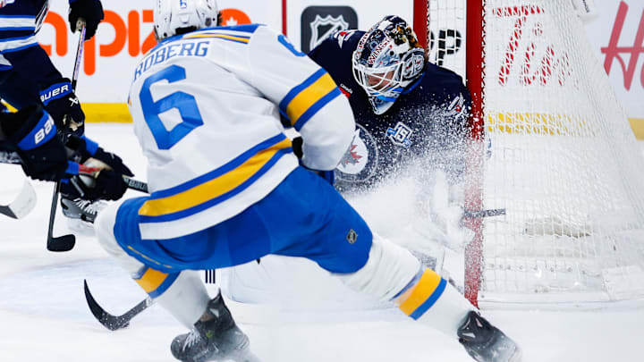 Jan 20, 2026; Winnipeg, Manitoba, CAN; St. Louis Blues defenseman Philip Broberg (6) skates in on Winnipeg Jets goalie Eric Comrie (1) during the first period at Canada Life Centre. Mandatory Credit: Terrence Lee-Imagn Images