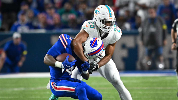 Sep 18, 2025; Orchard Park, New York, USA; Miami Dolphins free safety Minkah Fitzpatrick (29) tackles Buffalo Bills running back James Cook (4) in the first quarter at Highmark Stadium.