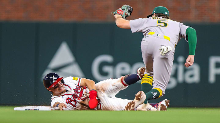 Mar 30, 2026; Cumberland, Georgia, USA; Athletics shortstop Jacob Wilson (5) makes a tag for an out against Atlanta Braves catcher Drake Baldwin (30) during the ninth inning at Truist Park. Mandatory Credit: Jordan Godfree-Imagn Images Mar 30, 2026; Cumberland, Georgia, USA; Athletics shortstop Jacob Wilson (5) makes a tag for an out against Atlanta Braves catcher Drake Baldwin (30) during the ninth inning at Truist Park. Mandatory Credit: Jordan Godfree-Imagn Images