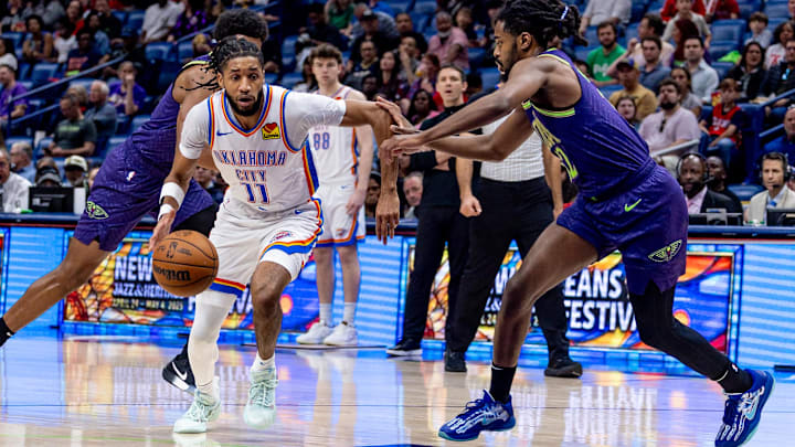 Apr 13, 2025; New Orleans, Louisiana, USA; Oklahoma City Thunder guard Isaiah Joe (11) dribbles against New Orleans Pelicans guard Antonio Reeves (12) during the first half at Smoothie King Center. Apr 13, 2025; New Orleans, Louisiana, USA; Oklahoma City Thunder guard Isaiah Joe (11) dribbles against New Orleans Pelicans guard Antonio Reeves (12) during the first half at Smoothie King Center.