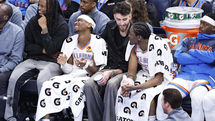 Feb 5, 2025; Oklahoma City, Oklahoma, USA; Oklahoma City Thunder guard Cason Wallace (22), guard Shai Gilgeous-Alexander (2), forward Chet Holmgren (7) and forward Jalen Williams (8) watch the game against the Phoenix Suns from the bench during the fourth quarter of a game at Paycom Center. Mandatory Credit: Alonzo Adams-Imagn Images Feb 5, 2025; Oklahoma City, Oklahoma, USA; Oklahoma City Thunder guard Cason Wallace (22), guard Shai Gilgeous-Alexander (2), forward Chet Holmgren (7) and forward Jalen Williams (8) watch the game against the Phoenix Suns from the bench during the fourth quarter of a game at Paycom Center. Mandatory Credit: Alonzo Adams-Imagn Images