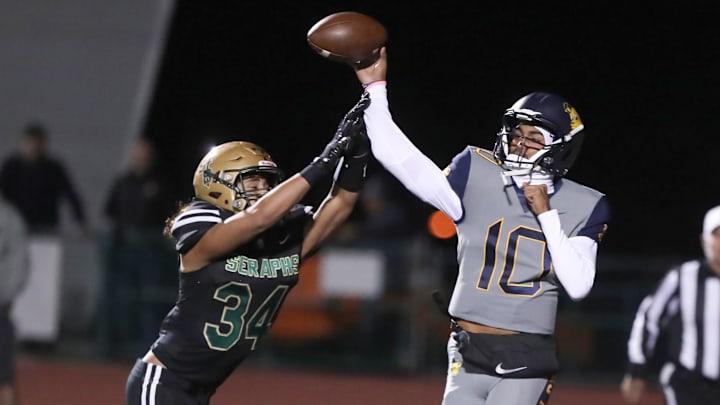 Warren quarterback Madden Iamaleava is under pressure by St. Bonaventure's Jacob Moraga as he fires a pass during the first quarter of the Seraphs' 24-21 win in the CIF-SS Division 3 championship game on Saturday, Nov. 25, 2023, at Ventura High's Larrabee Stadium.