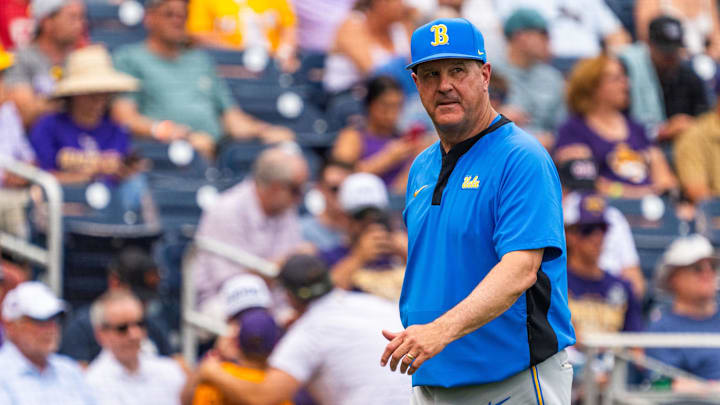 Jun 16, 2025; Omaha, Neb, USA; UCLA Bruins head coach John Savage walks off the field before the game against the LSU Tigers at Charles Schwab Field. Mandatory Credit: Dylan Widger-Imagn Images