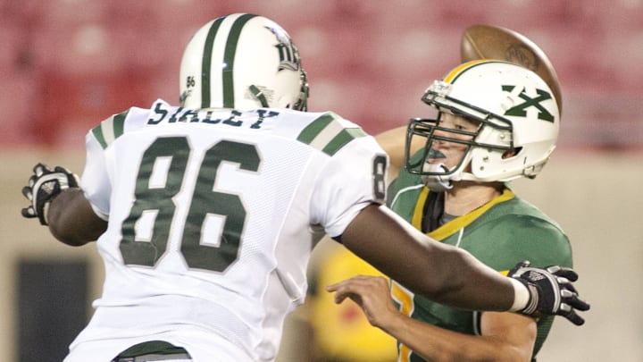 Dutch Forks Omar Staley pressures St. X's quarterback, Austin Gahafer as St. Xavier's Tigers take on the Dutch Fork Silver Foxes. 25 August 2012