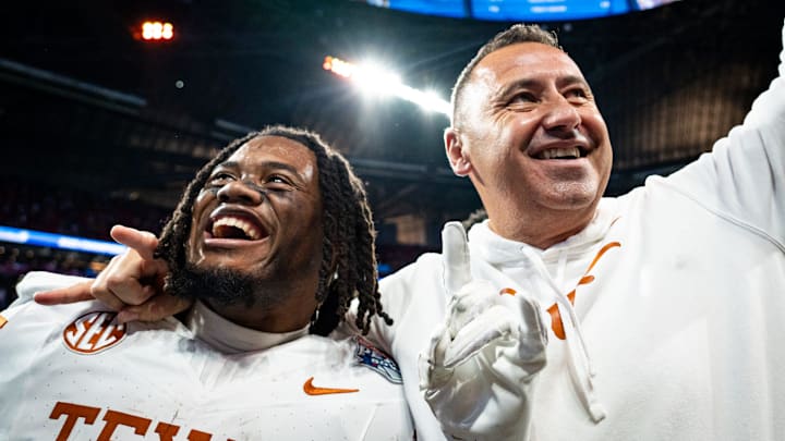 Texas Longhorns running back Jaydon Blue (23) and head coach Steve Sarkisian celebrate the Longhorns 39-31 double overtime win over the Arizona State Sun Devils in the Peach Bowl College Football Playoff quarterfinal at Mercedes-Benz Stadium in Atlanta, Georgia, Jan. 1, 2025.