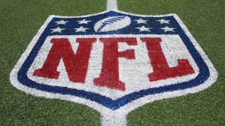 Aug 6, 2026; Canton, Ohio, USA;  The NFL shield logo on the field before the Carolina Panthers and Arizona Cardinals play at Tom Benson Hall of Fame Stadium. Mandatory Credit: Charles LeClaire-Imagn Images