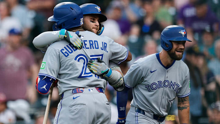 Aug 4, 2025; Denver, Colorado, USA; Toronto Blue Jays designated hitter Bo Bichette (11) celebrates his two run home run with first baseman Vladimir Guerrero Jr. (27) and right fielder Nathan Lukes (38) in the third inning against the Colorado Rockies at Coors Field. s