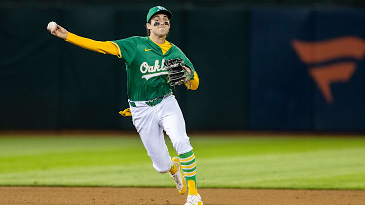 Sep 20, 2024; Oakland, California, USA; Oakland Athletics shortstop Jacob Wilson (5) throws to first during the eighth inning against the New York Yankees at Oakland-Alameda County Coliseum. Mandatory Credit: Bob Kupbens-Imagn Images