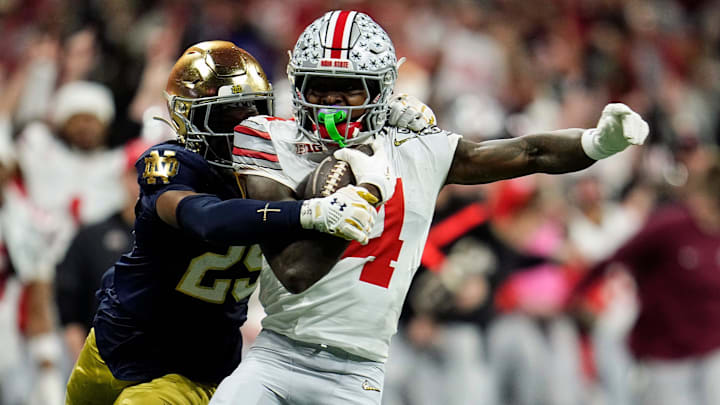 Ohio State Buckeyes wide receiver Jeremiah Smith (4) makes a catch against Notre Dame Fighting Irish cornerback Christian Gray (29) in the fourth quarter during the College Football Playoff National Championship at Mercedes-Benz Stadium in Atlanta on January 20, 2025.