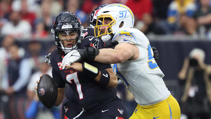 Jan 11, 2025; Houston, Texas, USA; Los Angeles Chargers outside linebacker Joey Bosa (97) sacks Houston Texans quarterback C.J. Stroud (7) during the first quarter in an AFC wild card game at NRG Stadium.
