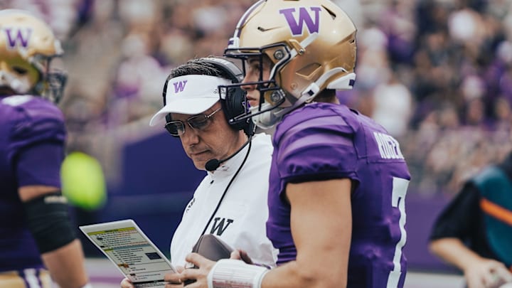 Jedd Fisch and Will Rogers stand together on the sideline.