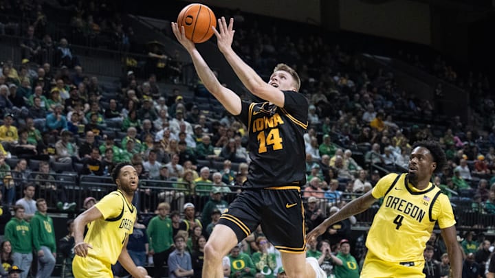 Iowa’s Bennett Stirtz, center, goes up for a shot against Oregon during the first half at Matthew Knight Arena in Eugene Feb 1, 2026. Iowa’s Bennett Stirtz, center, goes up for a shot against Oregon during the first half at Matthew Knight Arena in Eugene Feb 1, 2026.