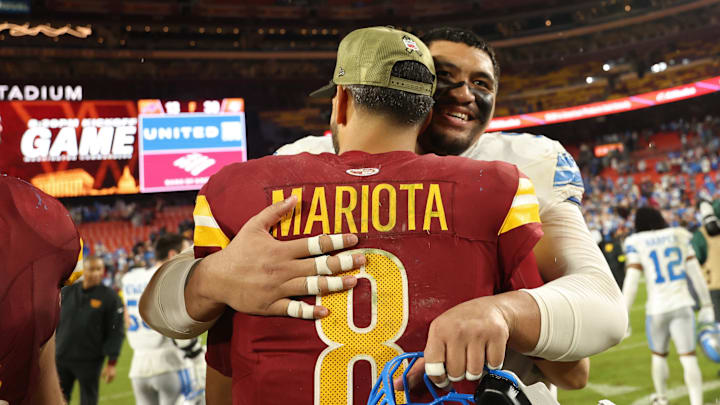 Nov 9, 2025; Landover, Maryland, USA; Washington Commanders quarterback Marcus Mariota (8) hugs Detroit Lions offensive tackle Penei Sewell (58) after their game at Northwest Stadium. Mandatory Credit: Geoff Burke-Imagn Images
