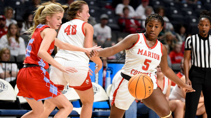 University Charter guard Anna Pezent (5) and Marion County guard Serinity Metcalfe (5) move to recover a losse ball during the state semifinal game Monday, Feb. 28, 2022, at Legacy Arena in Birmingham, Alabama.

University Charter Vs Marion County Ahsaa State Semifinal
