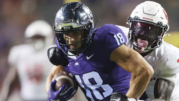 Oct 4, 2024; Fort Worth, Texas, USA; TCU Horned Frogs wide receiver Jack Bech (18) breaks the tackle of Houston Cougars defensive back Latrell McCutchin Sr. (1) and scores a touchdown in the fourth quarter at Amon G. Carter Stadium. Mandatory Credit: Tim Heitman-Imagn Images