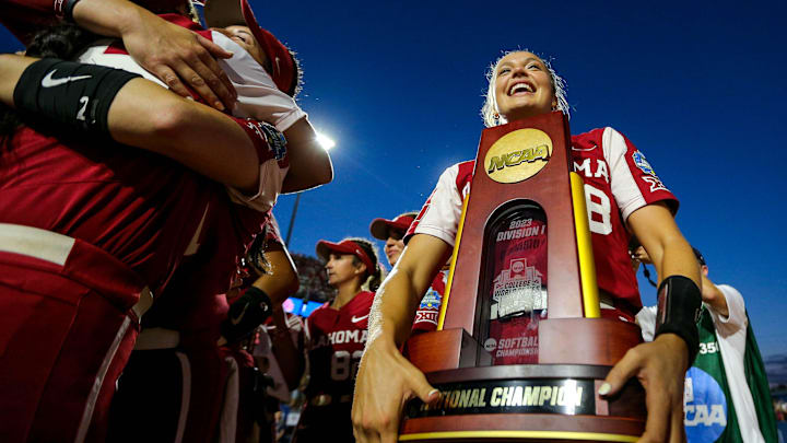 Oklahoma pitcher Alex Storako (8) holds the national championship trophy after OU wins the Women's