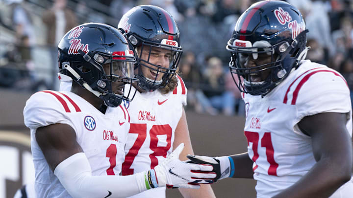 Oct 8, 2022; Nashville, Tennessee, USA; Mississippi Rebels wide receiver Jonathan Mingo (1) celebrates withy teammates Jeremy James (78) and Jayden Williams (71) after a 71 yard touchdown catch against the Vanderbilt Commodores during the third quarter at FirstBank Stadium. Mandatory Credit: George Walker IV - Imagn Images Oct 8, 2022; Nashville, Tennessee, USA; Mississippi Rebels wide receiver Jonathan Mingo (1) celebrates withy teammates Jeremy James (78) and Jayden Williams (71) after a 71 yard touchdown catch against the Vanderbilt Commodores during the third quarter at FirstBank Stadium. Mandatory Credit: George Walker IV - Imagn Images