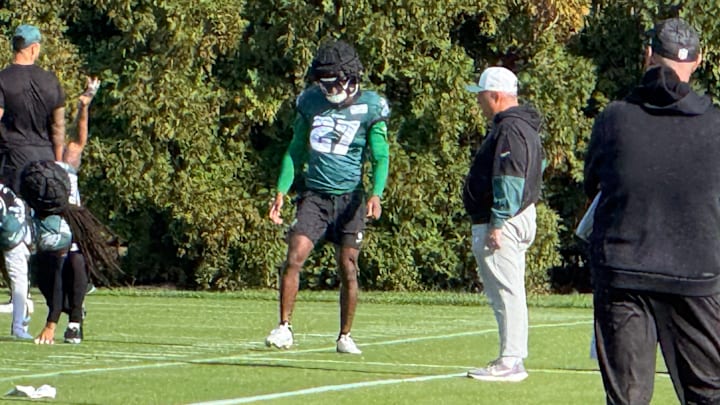 Quinyon Mitchell gets loose before a Week 7 practice with defensive coordinator Vic Fangio (right) looking on. Quinyon Mitchell gets loose before a Week 7 practice with defensive coordinator Vic Fangio (right) looking on.