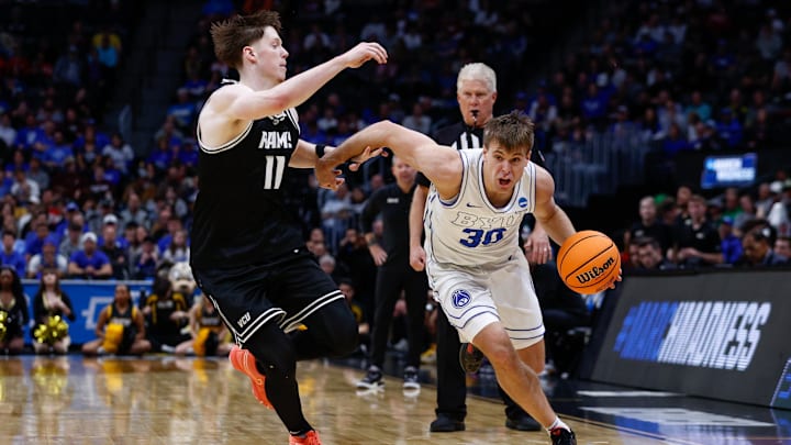 Mar 20, 2025; Denver, CO, USA; Brigham Young Cougars guard Dallin Hall (30) dribbles the ball against VCU Rams guard Max Shulga (11) during the second half in the first round of the NCAA Tournament at Ball Arena. Mandatory Credit: Isaiah J. Downing-Imagn Images