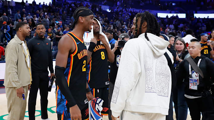 Dec 29, 2024; Oklahoma City, Oklahoma, USA; Oklahoma City Thunder guard Shai Gilgeous-Alexander (2) and Memphis Grizzlies guard Ja Morant (12) meet af Dec 29, 2024; Oklahoma City, Oklahoma, USA; Oklahoma City Thunder guard Shai Gilgeous-Alexander (2) and Memphis Grizzlies guard Ja Morant (12) meet af