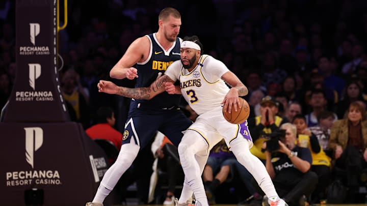 Nov 23, 2024; Los Angeles, California, USA;  Los Angeles Lakers forward Anthony Davis (3) posts up against Denver Nuggets center Nikola Jokic (15) during the first half at Crypto.com Arena. Mandatory Credit: Kiyoshi Mio-Imagn Images