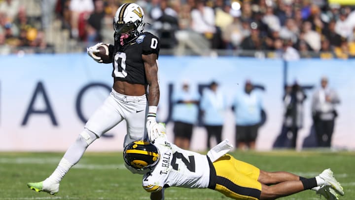Dec 31, 2025; Tampa, FL, USA; Iowa Hawkeyes defensive back TJ Hall (2) trips up Vanderbilt Commodores wide receiver Junior Sherrill (0) in the second quarter during the ReliaQuest Bowl at Raymond James Stadium. Mandatory Credit: Nathan Ray Seebeck-Imagn Images
