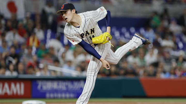 Mar 20, 2023; Miami, Florida, USA; Japan starting pitcher Roki Sasaki (14) delivers a pitch during the first inning against Mexico at LoanDepot Park. Mandatory Credit: Sam Navarro-Imagn Images