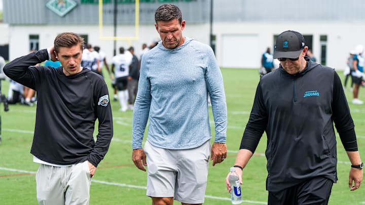Jacksonville Jaguars general manager James Gladstone, left, Jacksonville Jaguars is executive vice president of football operations Tony Boselli, center and Jacksonville Jaguars head coach Liam Coen, right, all talk on the field after the Jacksonville Jaguars’ mandatory minicamp Tuesday June 10, 2025 at the Miller Electric Center in Jacksonville, Fla. [Doug Engle/Florida Times-Union]