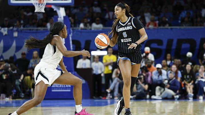 Aug 25, 2025; Chicago, Illinois, USA; Chicago Sky forward Angel Reese (5) brings the ball up court against Las Vegas Aces guard Jackie Young (0) during the first half at Wintrust Arena. Mandatory Credit: Kamil Krzaczynski-Imagn Images