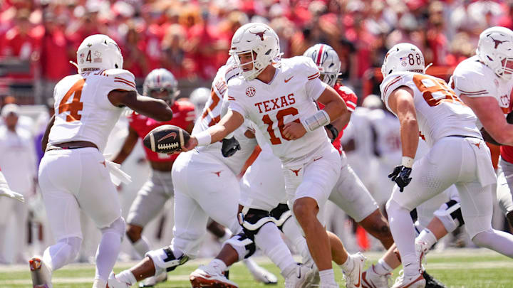 Texas Longhorns quarterback Arch Manning (16) hands off to running back CJ Baxter (4) during the NCAA football game against the Ohio State Buckeyes at Ohio Stadium on Aug. 30, 2025.